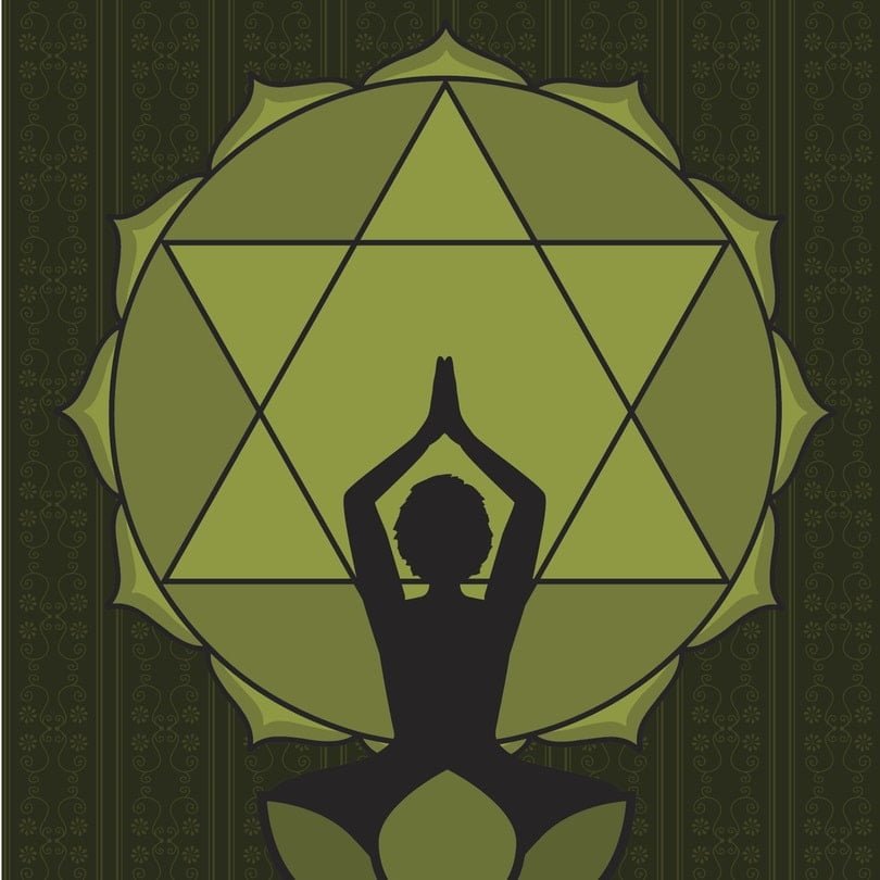 woman practicing yoga in front of heart chakra symbol