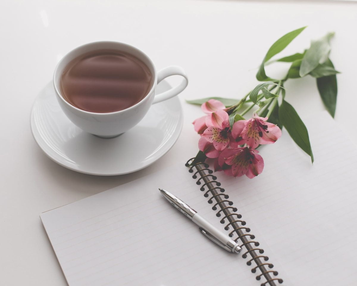 manifesting journal and cup of tea
