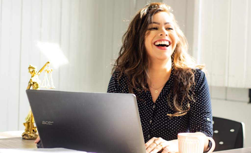 Happy woman on her laptop