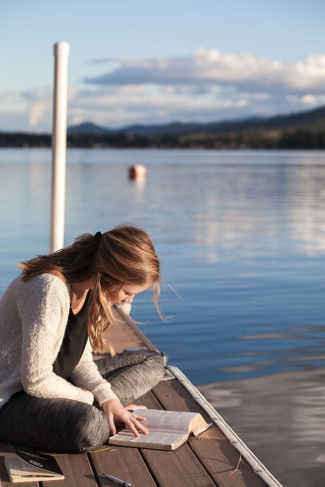 woman studying on a dock