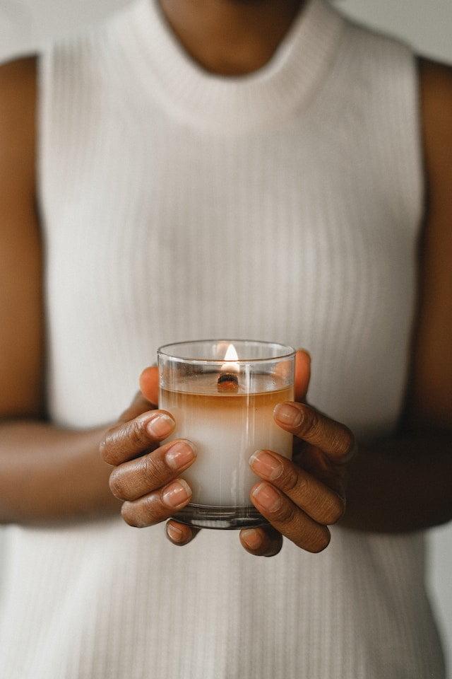 woman holding white candle
