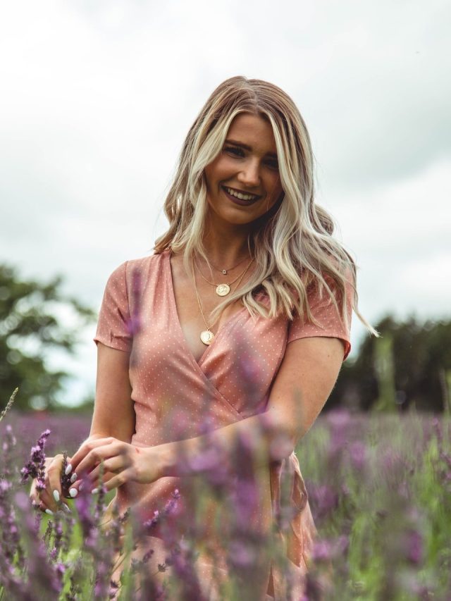 smiling woman standing in lavender field
