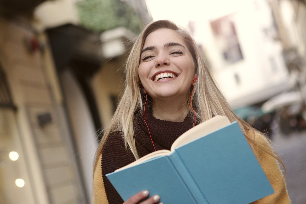 smiling woman holding book