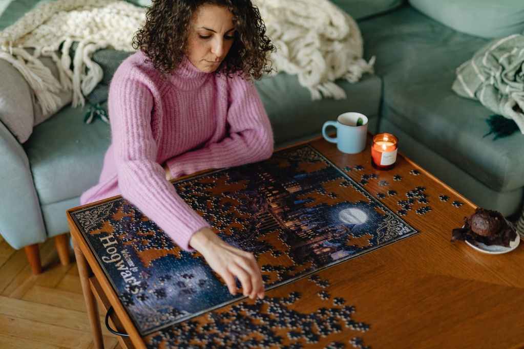 woman sitting on floor doing hogwards puzzle