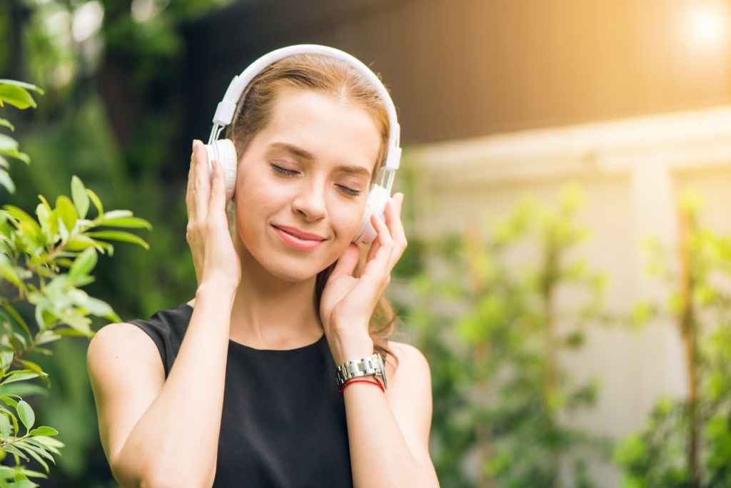 woman outdoors wearing headphones