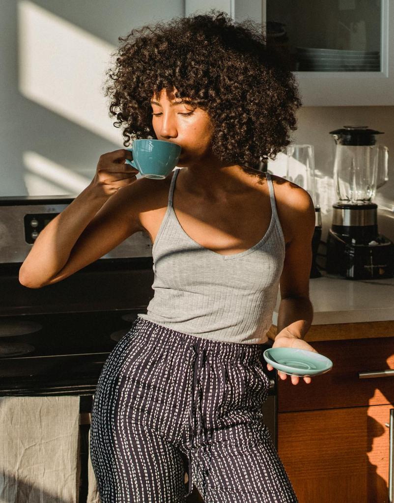 woman enjoying a cup of coffee in the kitchen