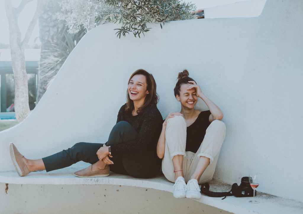 Two women sitting outside and laughing