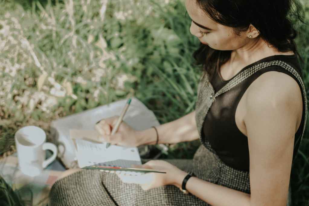 woman journaling outdoors