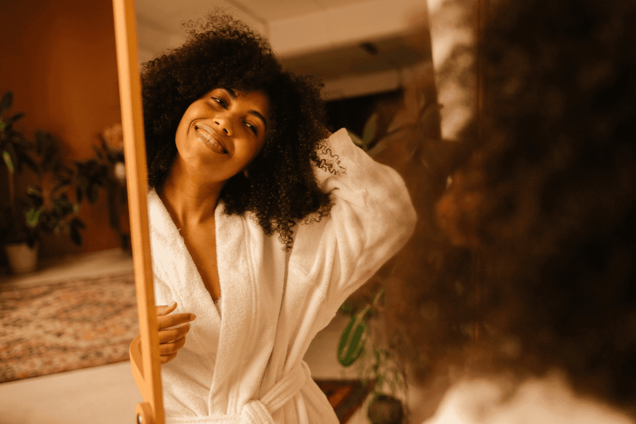 smiling woman looking in mirror
